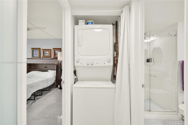 laundry area featuring stacked washer and clothes dryer