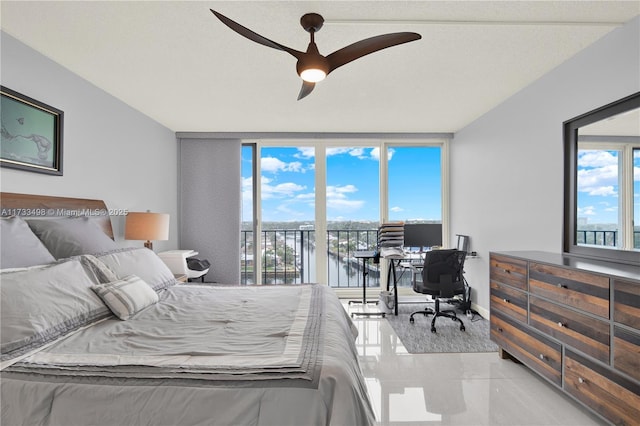 bedroom featuring light tile patterned flooring, ceiling fan, floor to ceiling windows, and access to outside