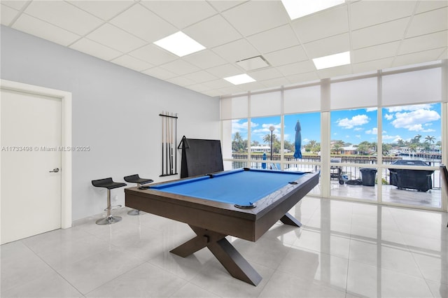 playroom with floor to ceiling windows, light tile patterned flooring, a drop ceiling, and billiards