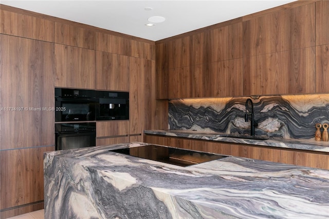 kitchen with black appliances and dark stone counters