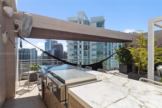 view of patio / terrace featuring a balcony and an outdoor kitchen