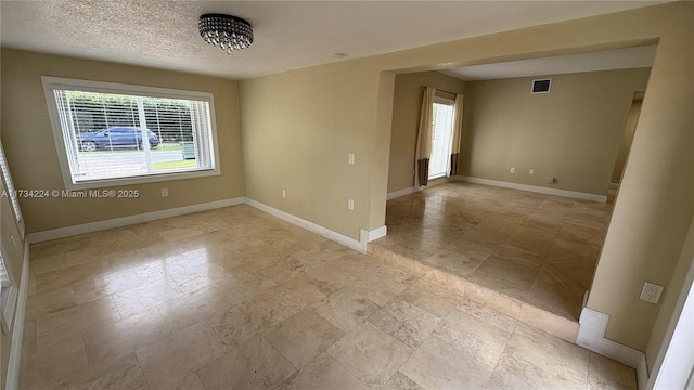 empty room with a textured ceiling