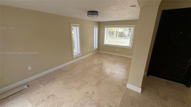 spare room featuring a textured ceiling