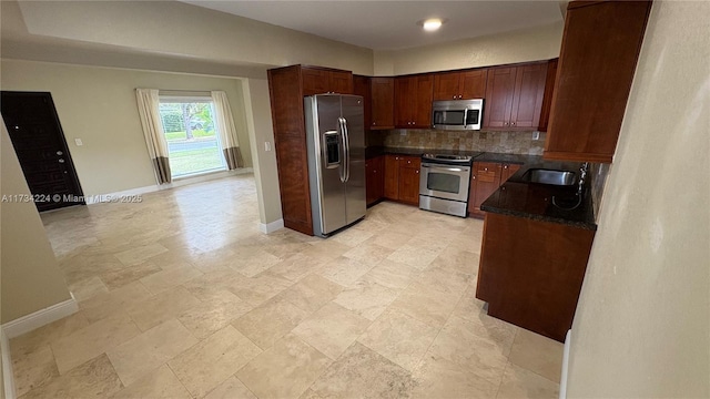 kitchen with sink, backsplash, and appliances with stainless steel finishes