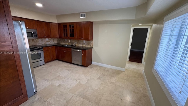 kitchen with backsplash, stainless steel appliances, and sink