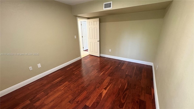 empty room with dark hardwood / wood-style floors