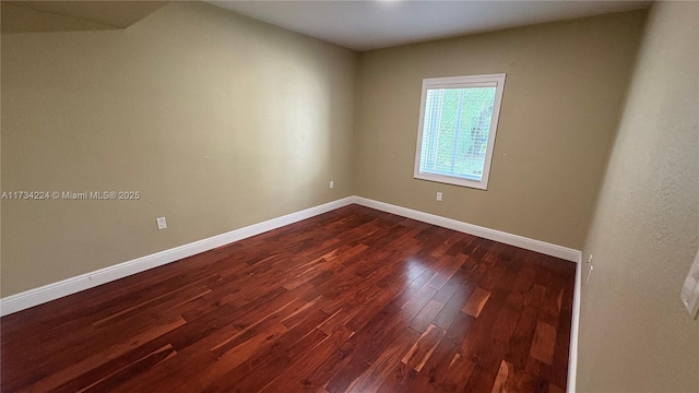 empty room featuring dark wood-type flooring