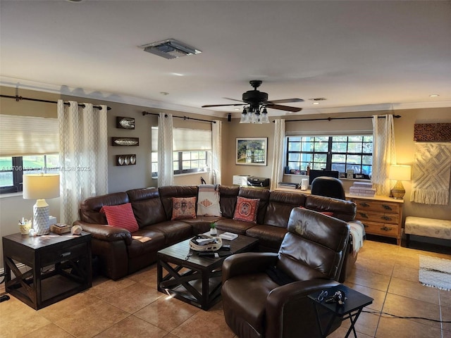 tiled living room with ornamental molding, a healthy amount of sunlight, and ceiling fan