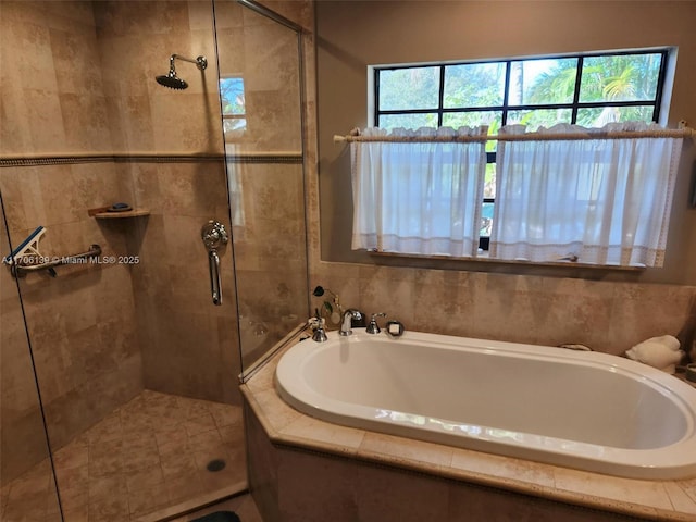 bathroom featuring plenty of natural light and plus walk in shower