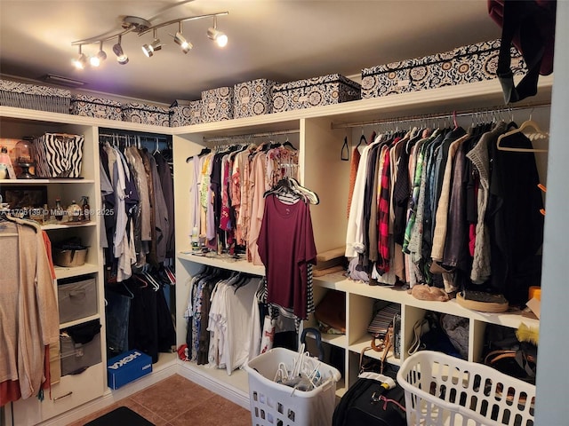 walk in closet with tile patterned floors