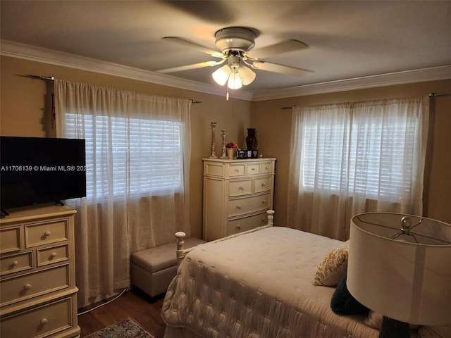 bedroom with ceiling fan, ornamental molding, dark hardwood / wood-style flooring, and multiple windows