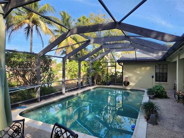 view of swimming pool with a patio and glass enclosure