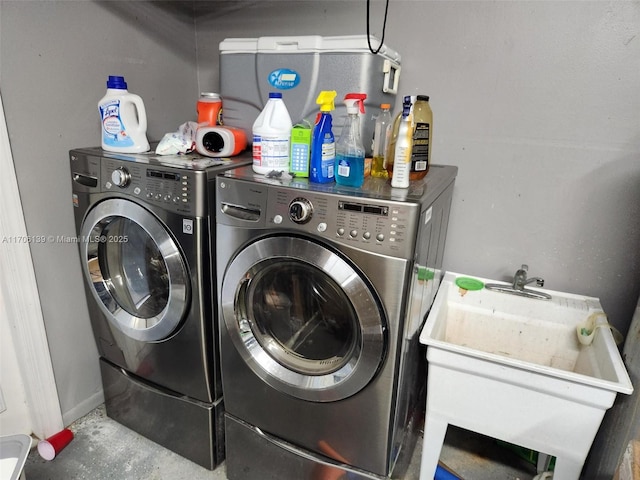 clothes washing area featuring separate washer and dryer and sink