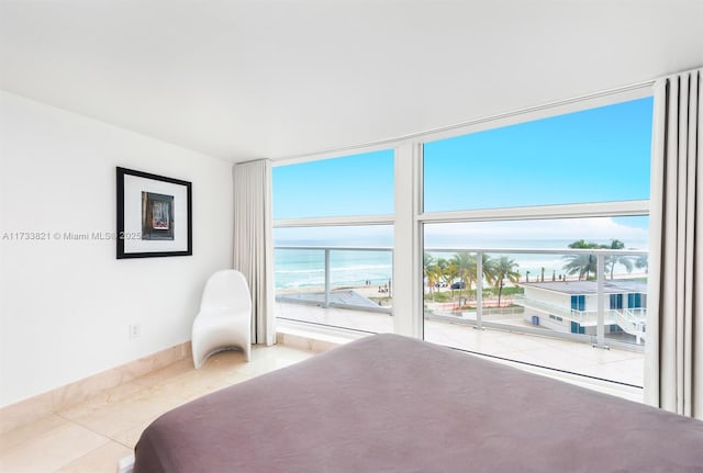 5445 Collins Ave Unit M15, Miami Beach, FL 33140 - unfurnished bedroom featuring tile patterned flooring, a water view, and expansive windows