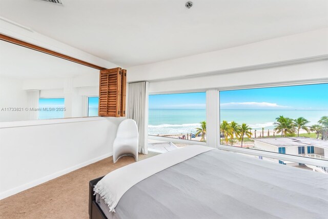 5445 Collins Ave Unit M15, Miami Beach, FL 33140 - bedroom featuring a view of the beach, baseboards, carpet, and a water view