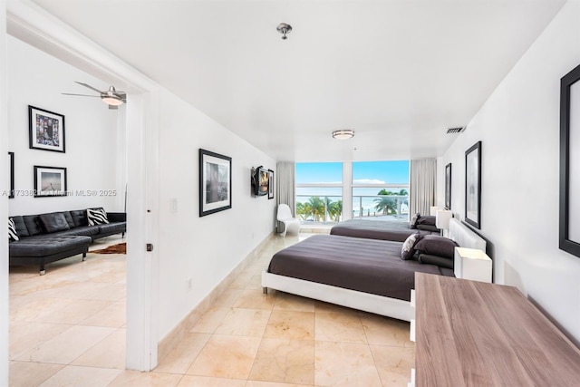 bedroom with ceiling fan and light tile patterned floors