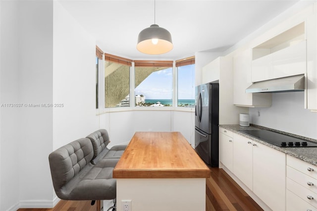 kitchen featuring decorative light fixtures, dark wood-type flooring, white cabinets, and black appliances