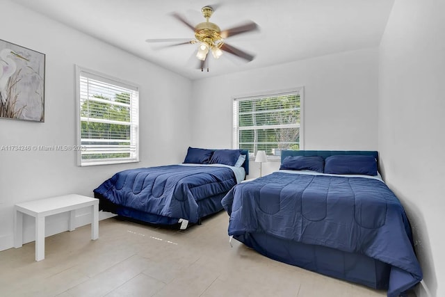 bedroom with multiple windows and ceiling fan