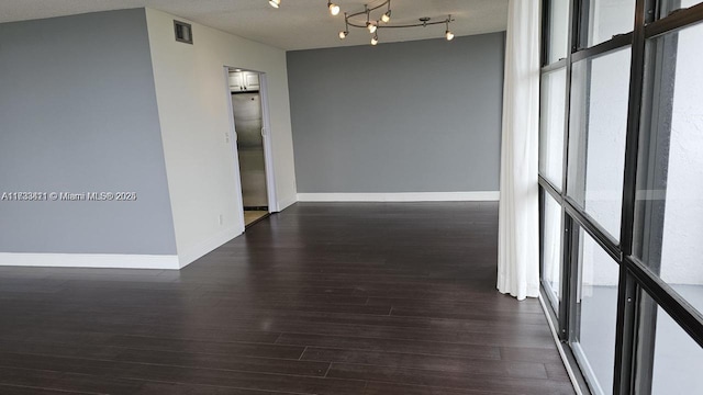 hall featuring dark hardwood / wood-style floors and a textured ceiling