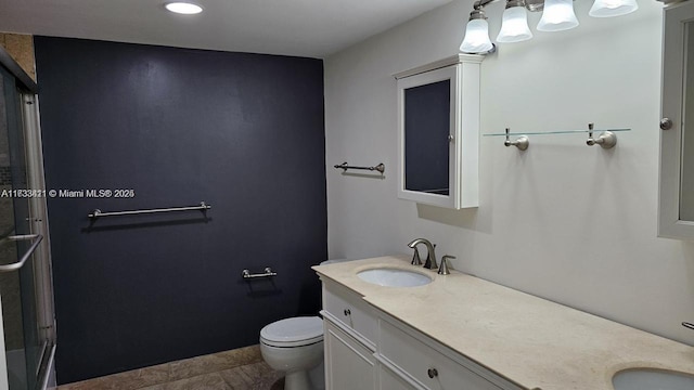 bathroom with vanity, walk in shower, and toilet