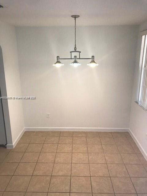 unfurnished room with light tile patterned floors