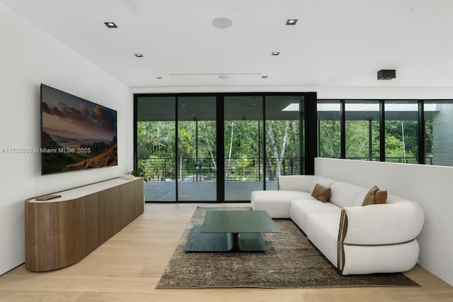 4040 Kiaora St, Miami, FL 33133 - living room featuring a wall of windows, healthy amount of natural light, and light wood-style floors