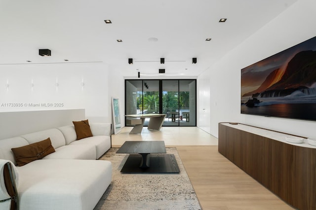 4040 Kiaora St, Miami, FL 33133 - living room with expansive windows and light wood-style flooring