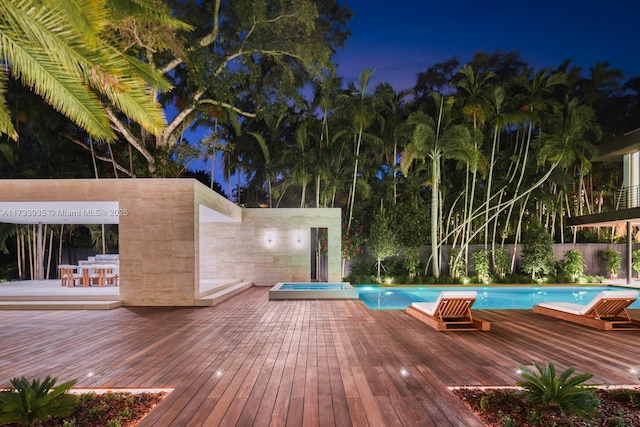 4040 Kiaora St, Miami, FL 33133 - pool at night featuring a deck and a pool with connected hot tub