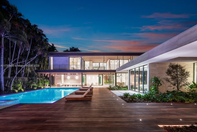 4040 Kiaora St, Miami, FL 33133 - pool at dusk featuring an outdoor pool and a wooden deck