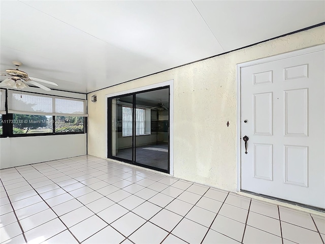 interior space featuring ceiling fan and light tile patterned floors