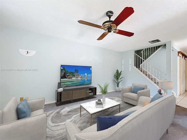 carpeted living room featuring ceiling fan