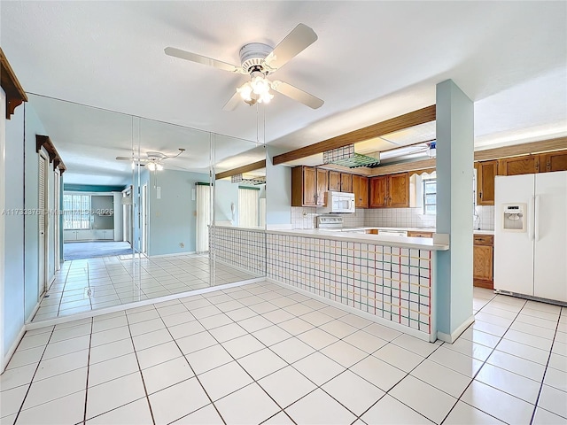 kitchen featuring backsplash, white appliances, kitchen peninsula, and light tile patterned flooring