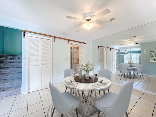 dining room with light tile patterned floors and ceiling fan