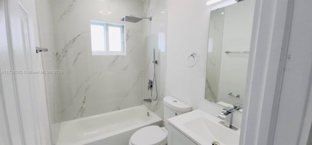 full bathroom featuring tiled shower / bath, vanity, and toilet