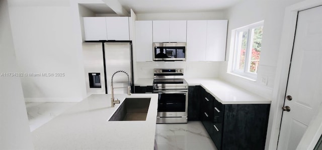 kitchen featuring white cabinetry, sink, tasteful backsplash, and appliances with stainless steel finishes