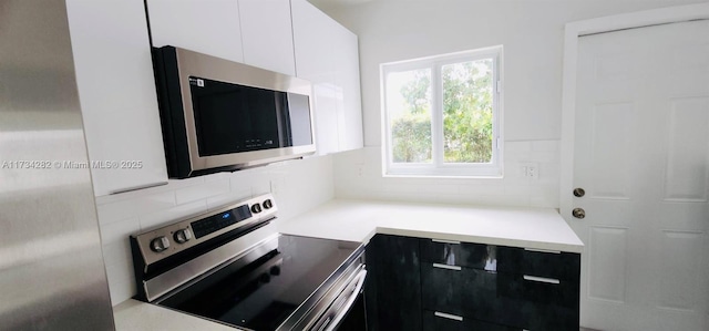 kitchen with stainless steel appliances and white cabinets