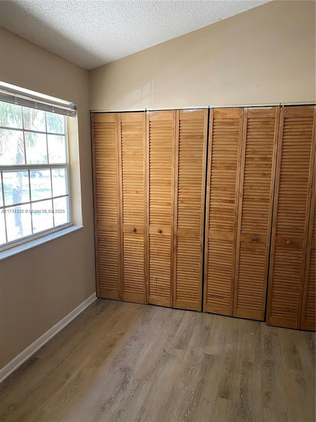 interior space featuring hardwood / wood-style floors and a textured ceiling