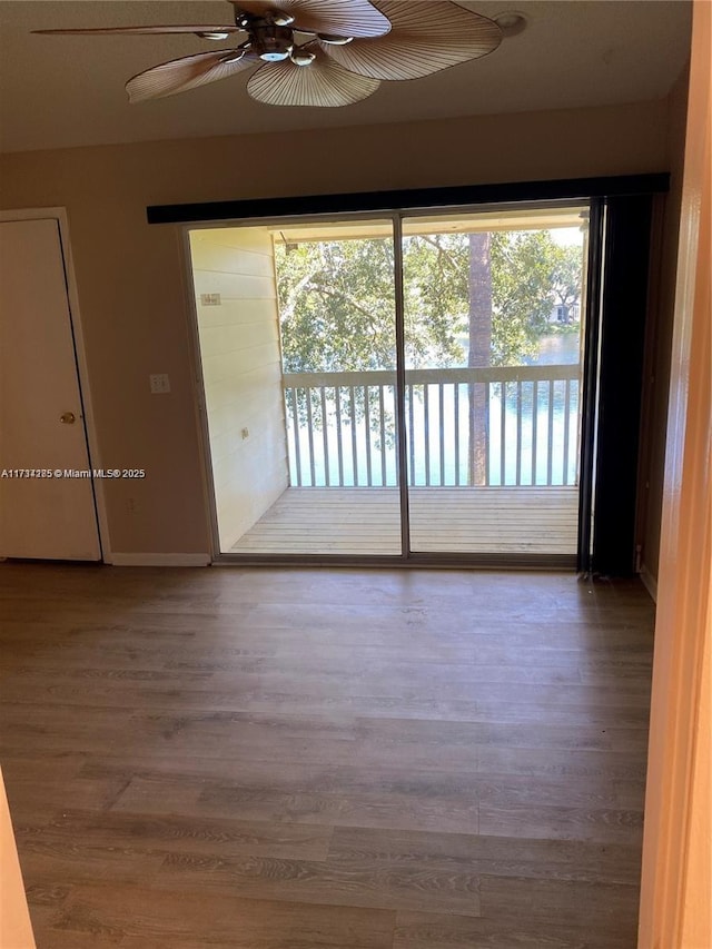 spare room with wood-type flooring and ceiling fan