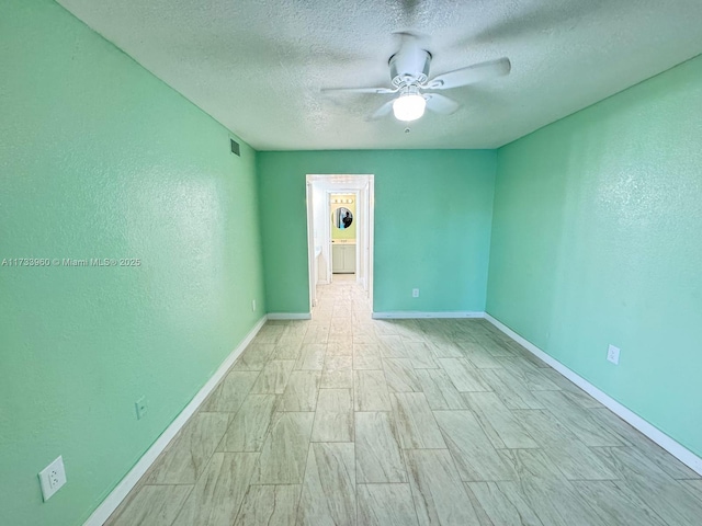 spare room with ceiling fan and a textured ceiling