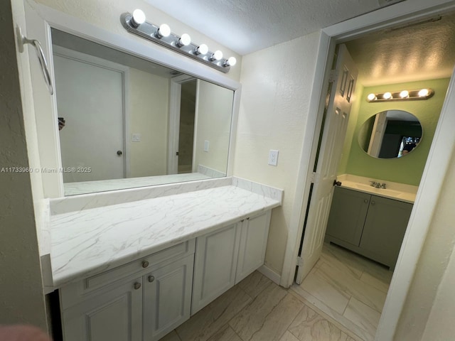 bathroom featuring vanity and a textured ceiling