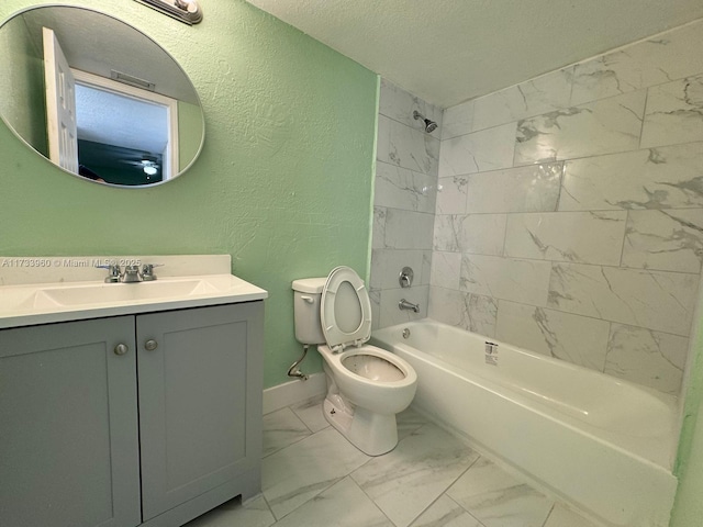 full bathroom with vanity, tiled shower / bath combo, a textured ceiling, and toilet