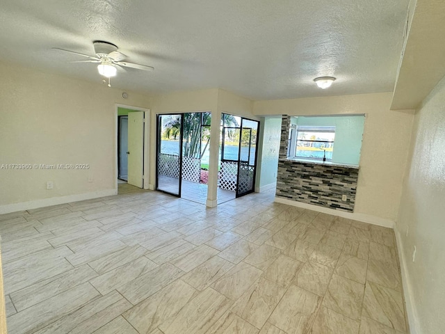 spare room featuring ceiling fan and a textured ceiling