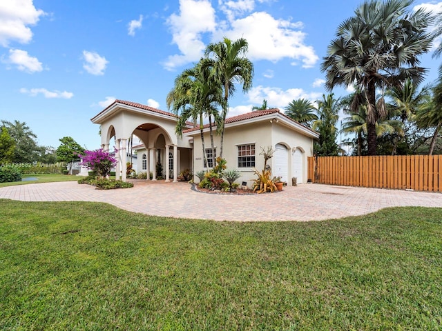 view of front of house with a garage and a front lawn