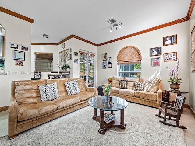 living room featuring light tile patterned flooring, crown molding, track lighting, and a textured ceiling