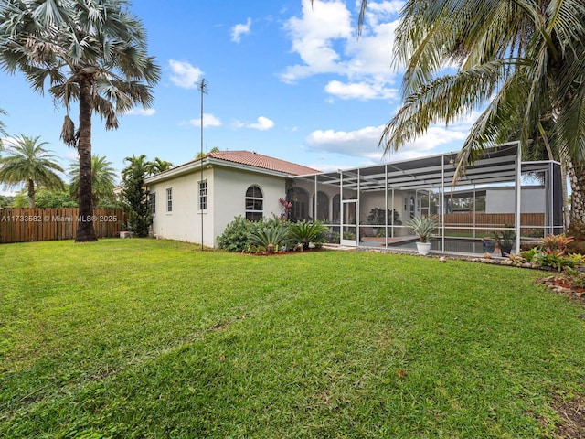 back of property featuring a pool, a yard, and a lanai