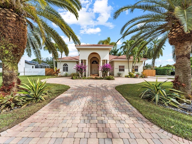 mediterranean / spanish house featuring a front lawn