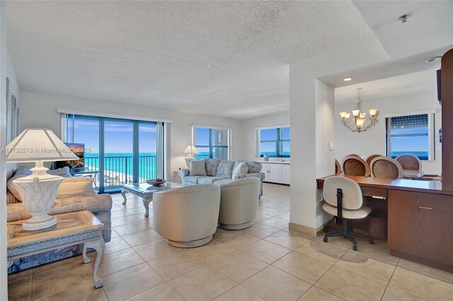 balcony with a water view and a view of the beach