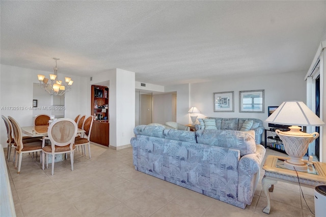 living room with a textured ceiling and a notable chandelier