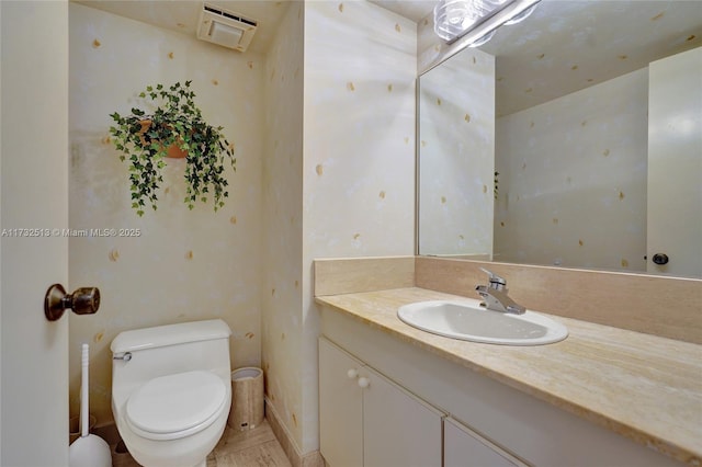 bathroom featuring vanity and toilet