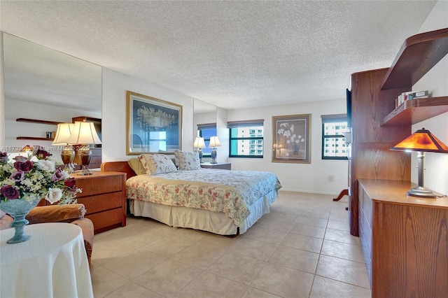 tiled bedroom featuring a textured ceiling